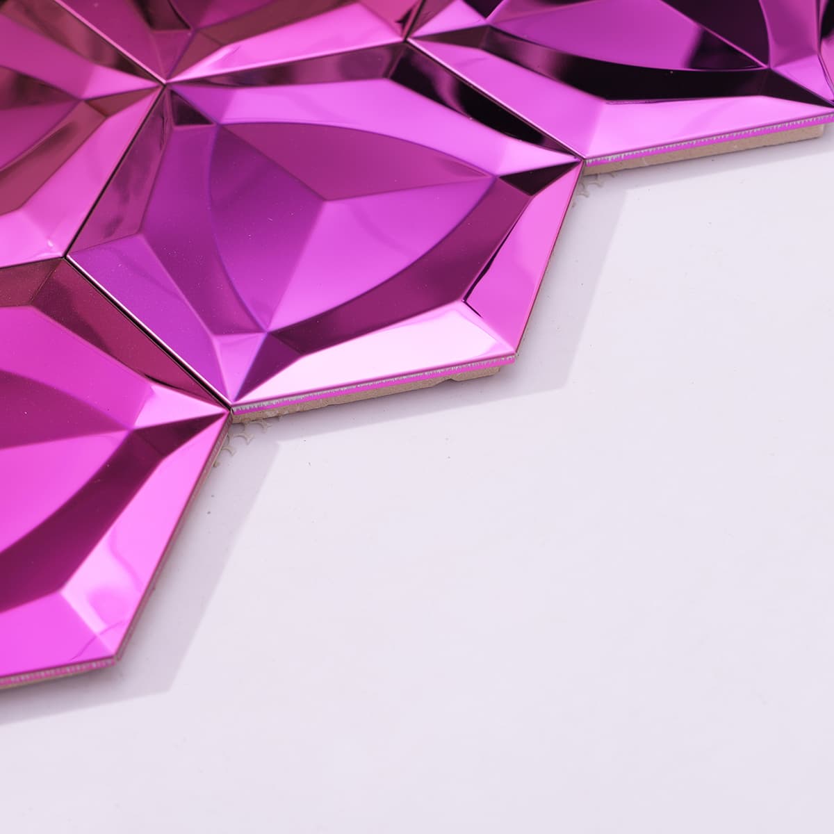 Side view of mirrored pink stainless steel hexagon mosaic tiles