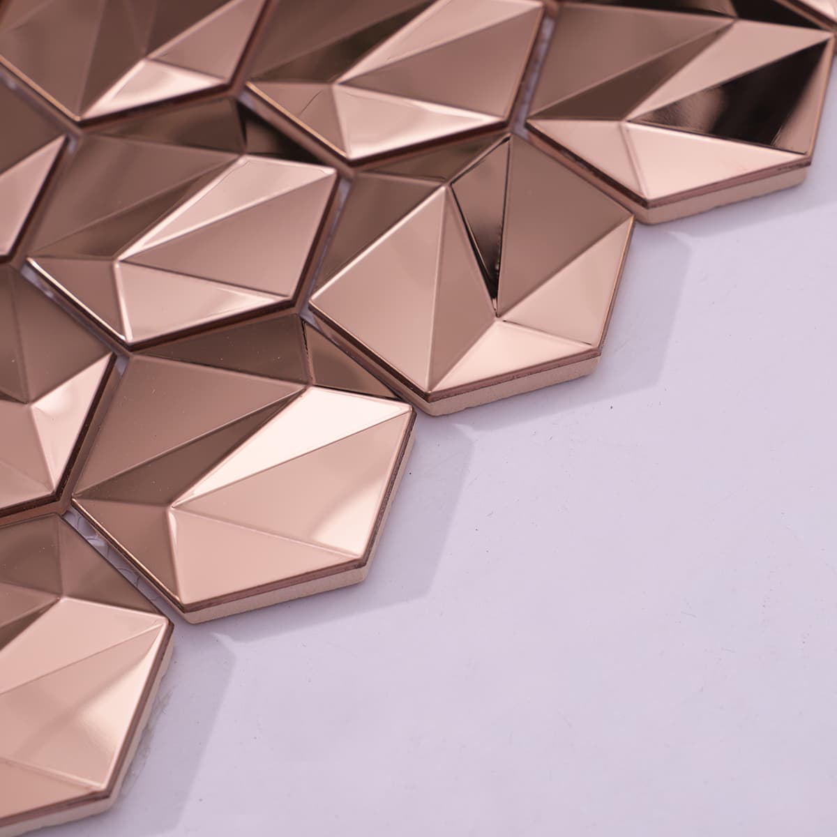 Side angle of raised 3D rose gold hexagon mosaic pieces