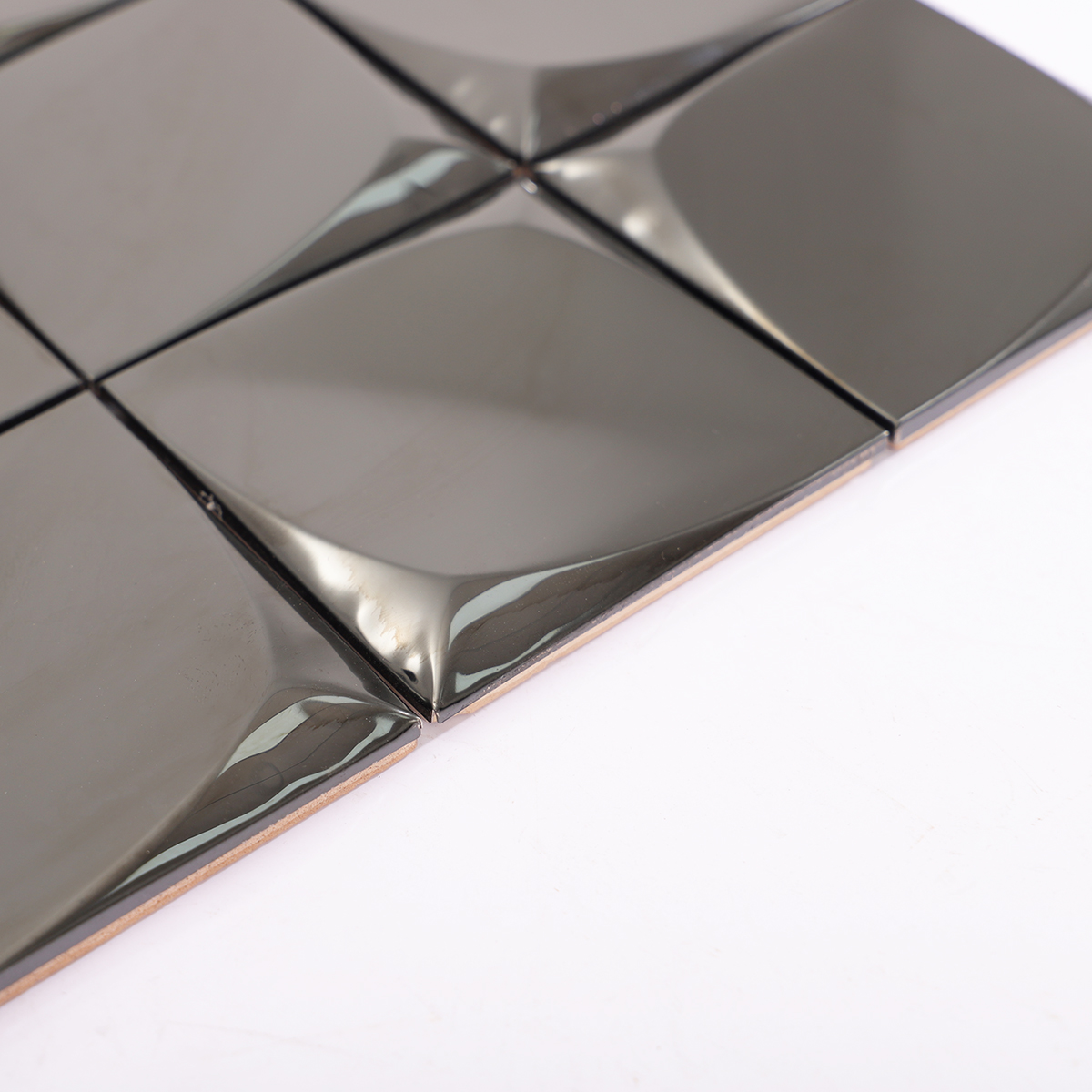 Angled shot showcasing the depth and thickness of the 3D stainless steel tiles.