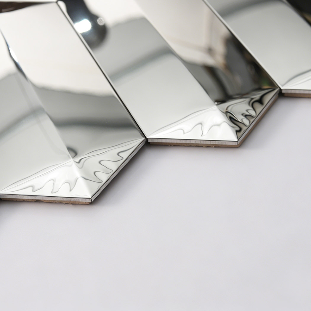 Side close up of silver mirror mosaic tile showing thickness and beveled edges