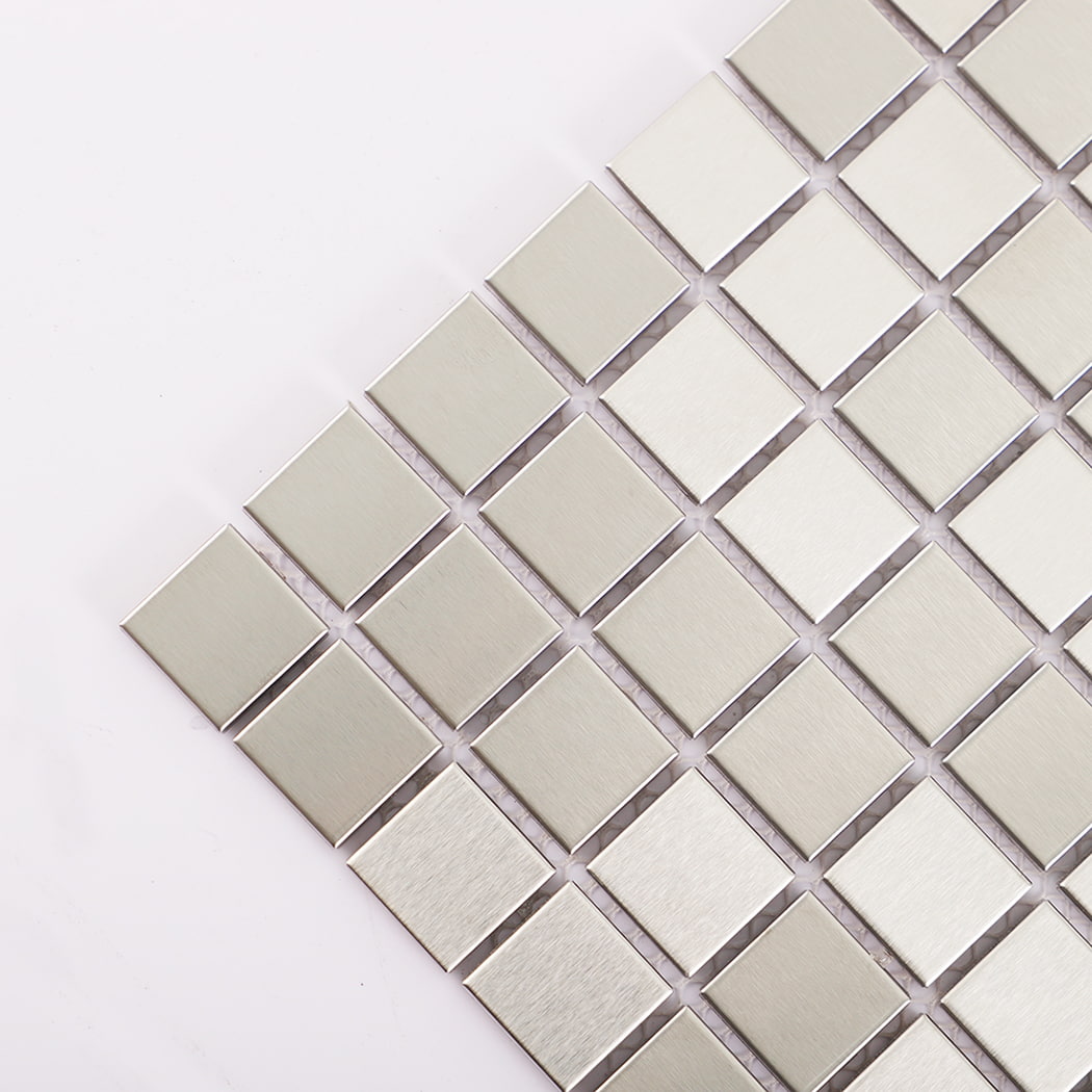 Corner close-up of silver stainless steel square mosaic tile surface.