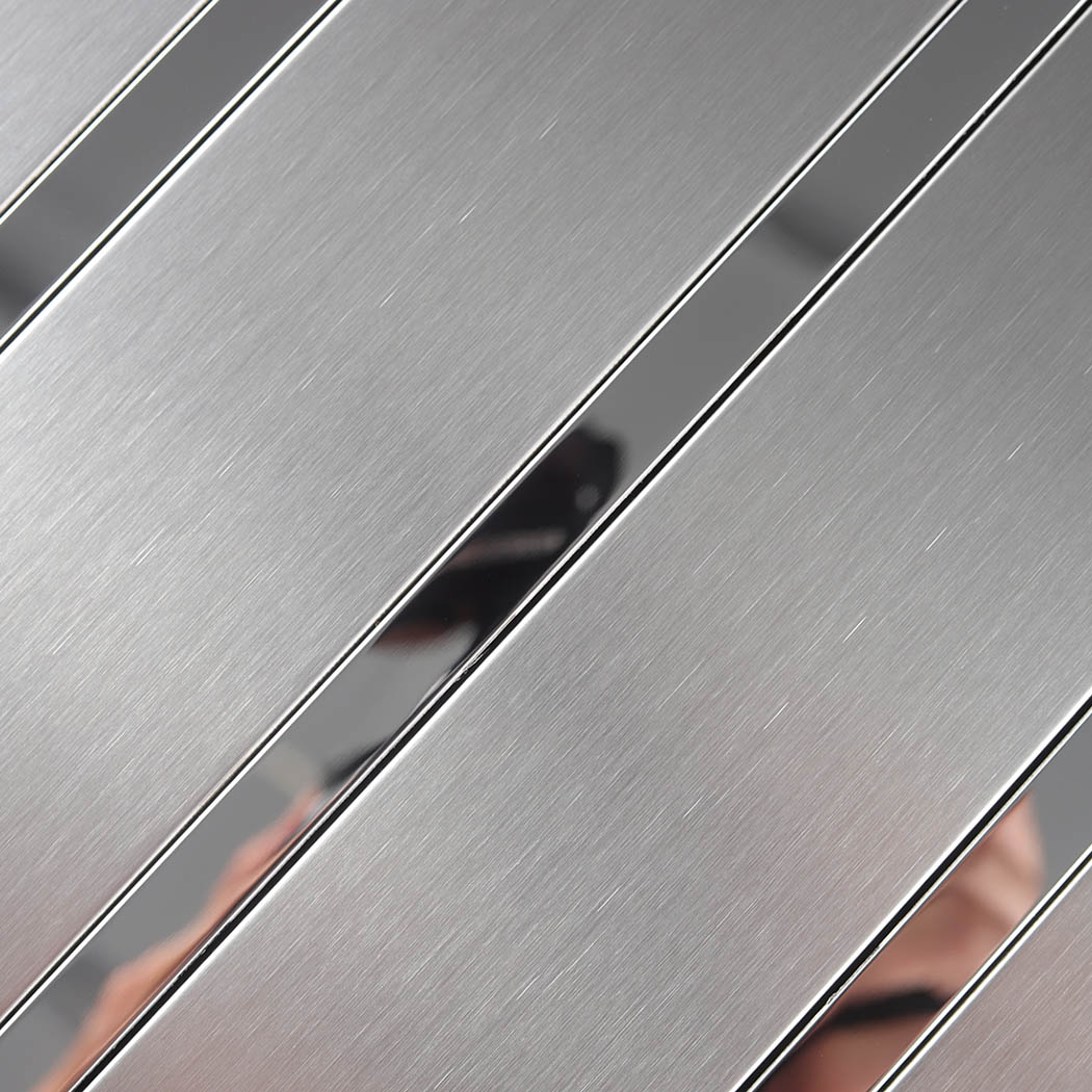 Close-up of brushed silver tile with reflective stainless steel strips