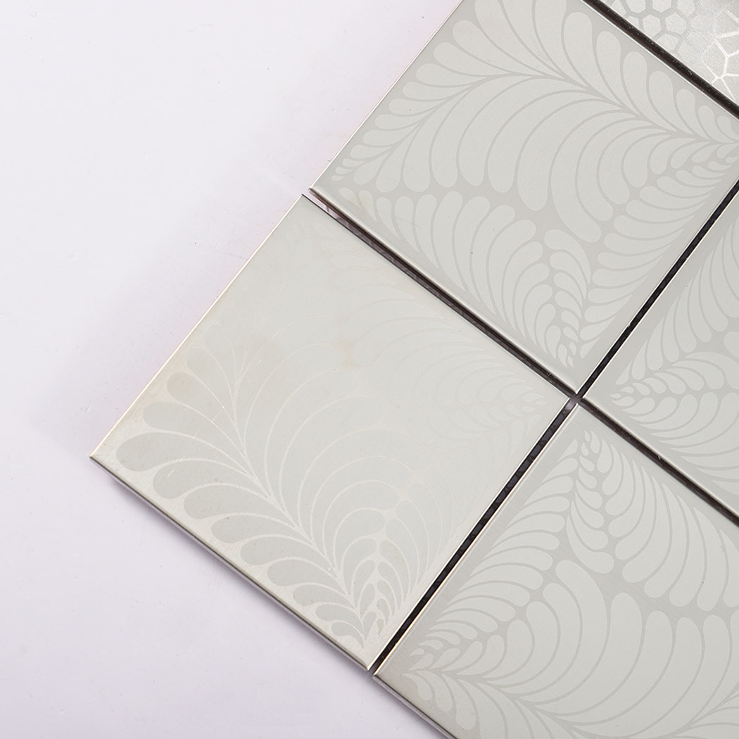 Corner close up of silver brushed square stainless steel tiles with subtle swirl