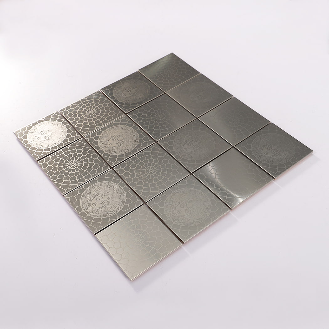 Angled view of silver brushed square stainless steel mosaic tile sheet on white background.