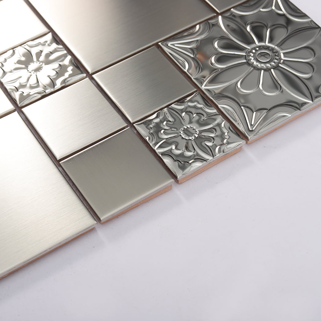 Surface detail of silver embossed floral metal mosaic tile with raised patterns