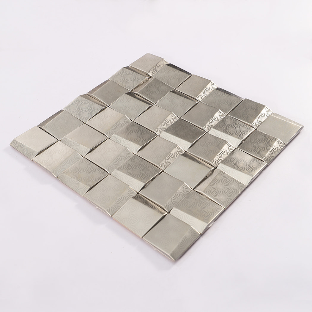 Angled view of silver stainless steel metal mosaic sheet with raised square tiles 