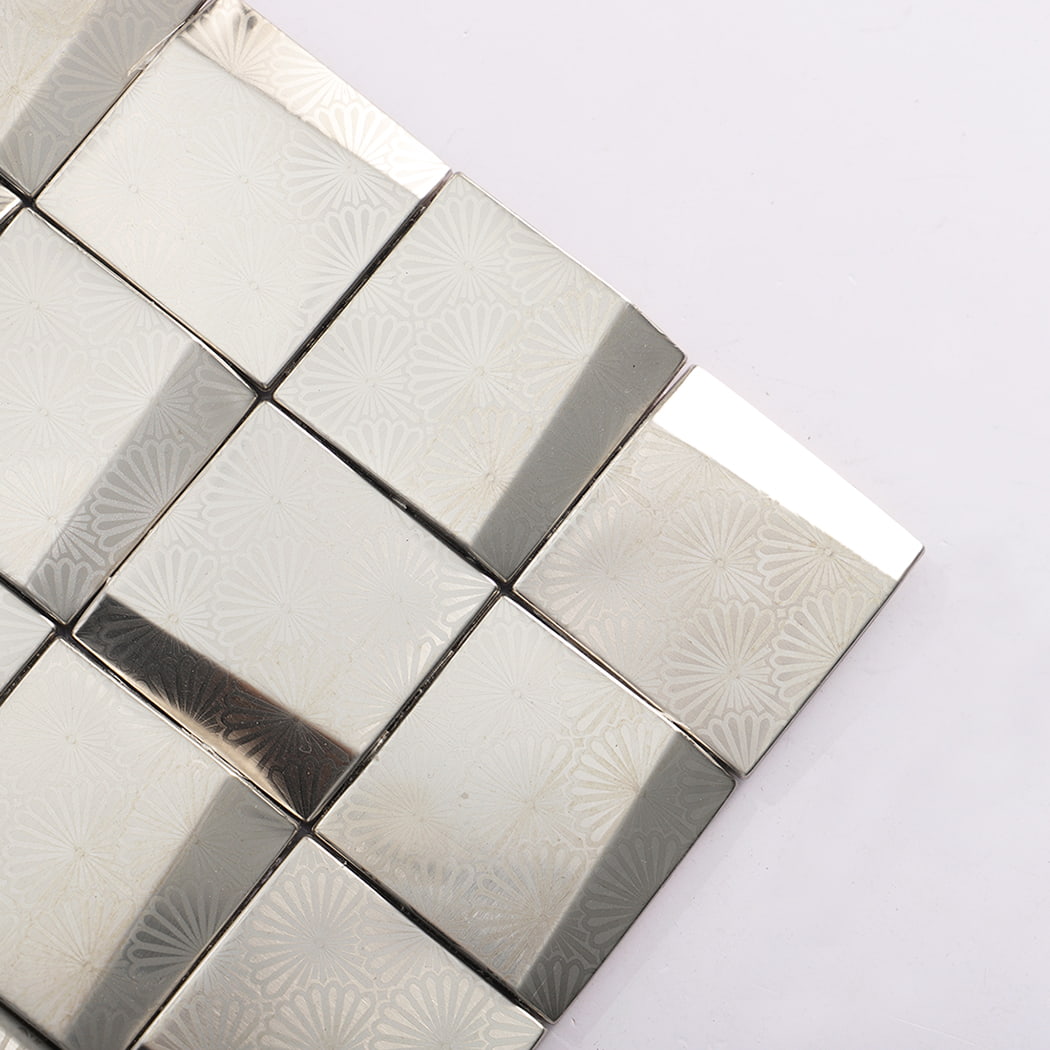 Corner close up of 3D silver stainless steel metal mosaic tiles with subtle floral pattern.