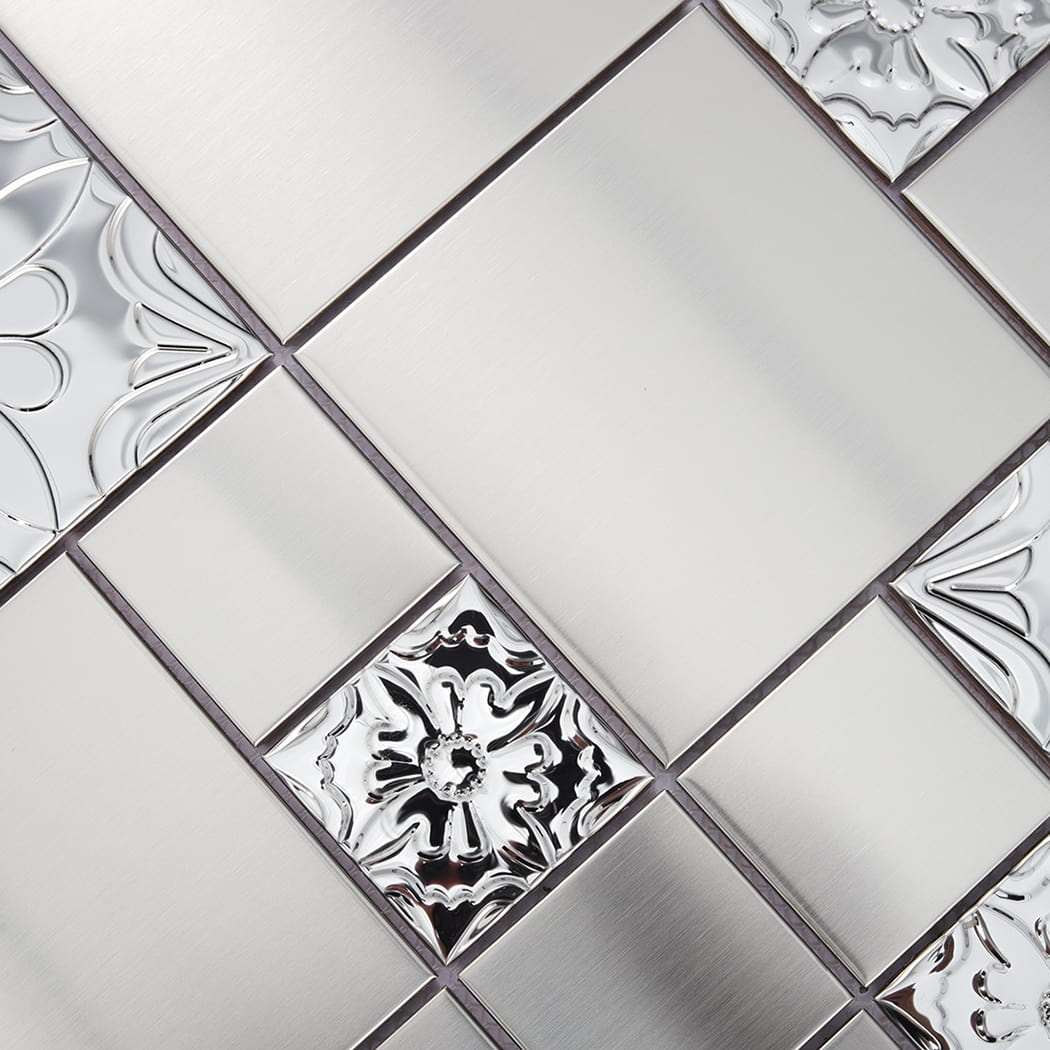 Detail of silver stainless steel square mosaic tile combining brushed and embossed textures