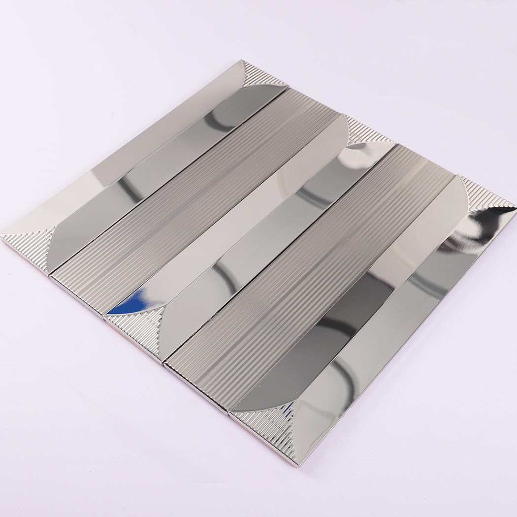 Angled view of silver stainless steel subway tile on white background
