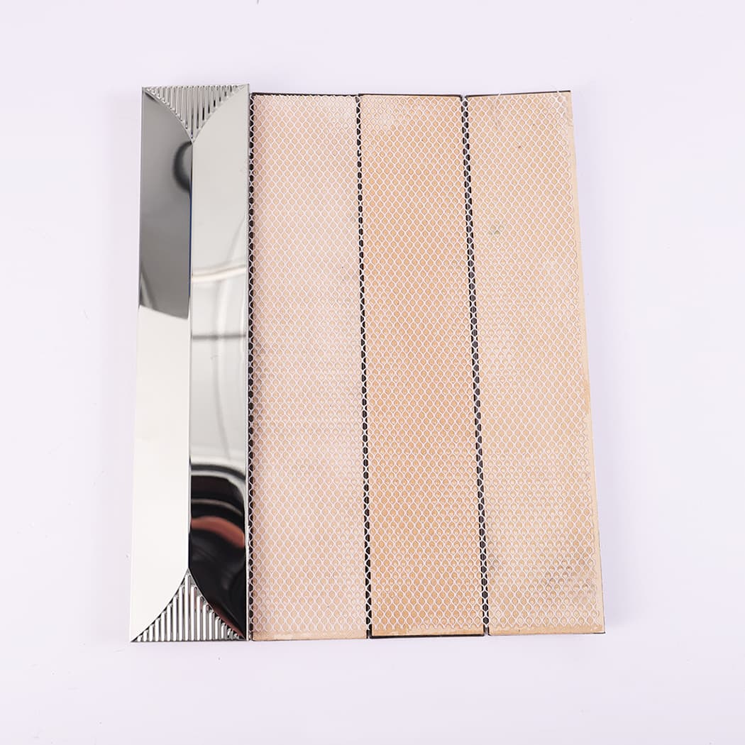 Back side of silver stainless steel tile showing mesh backing and structure