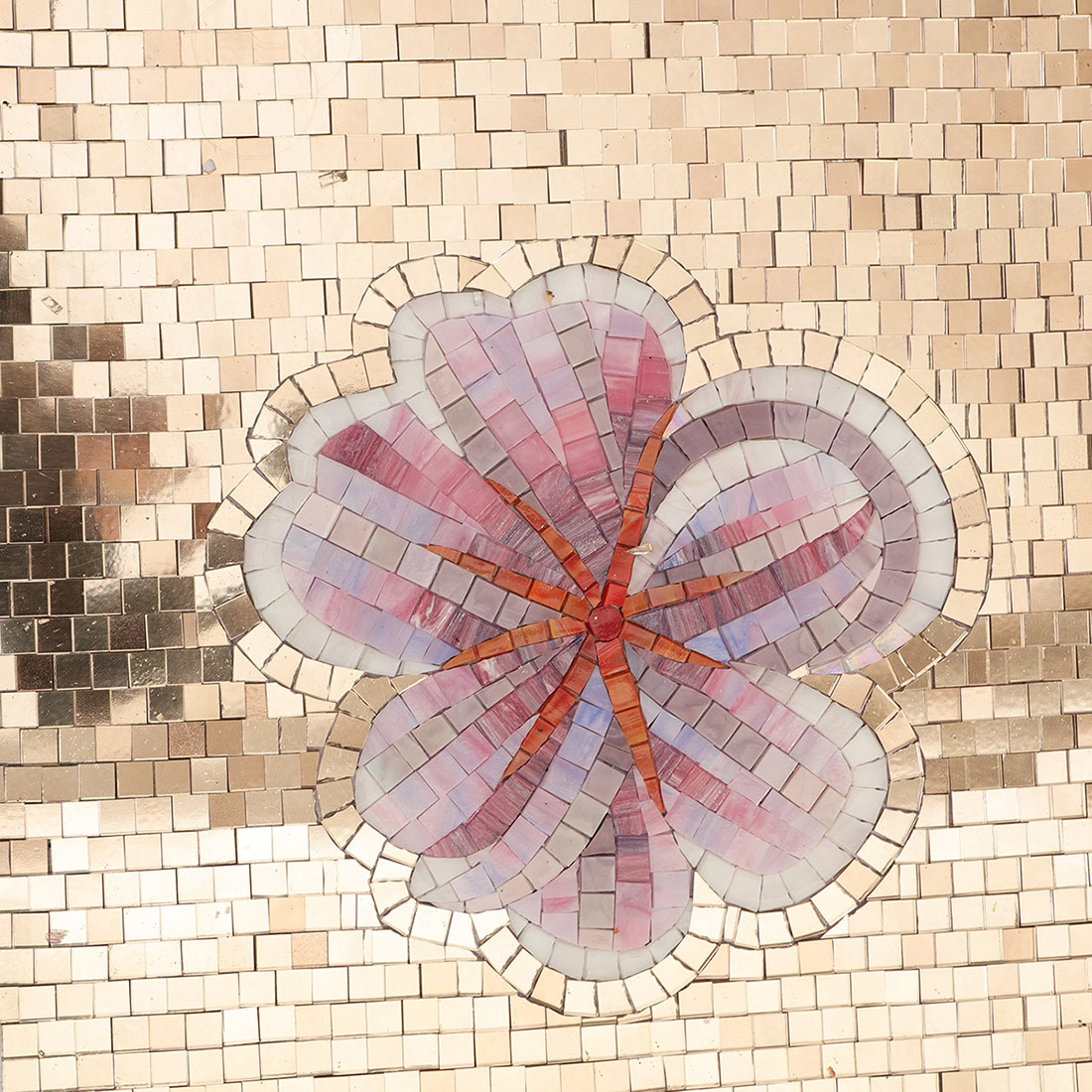 Small cream flower detail on a handmade glass mosaic mural