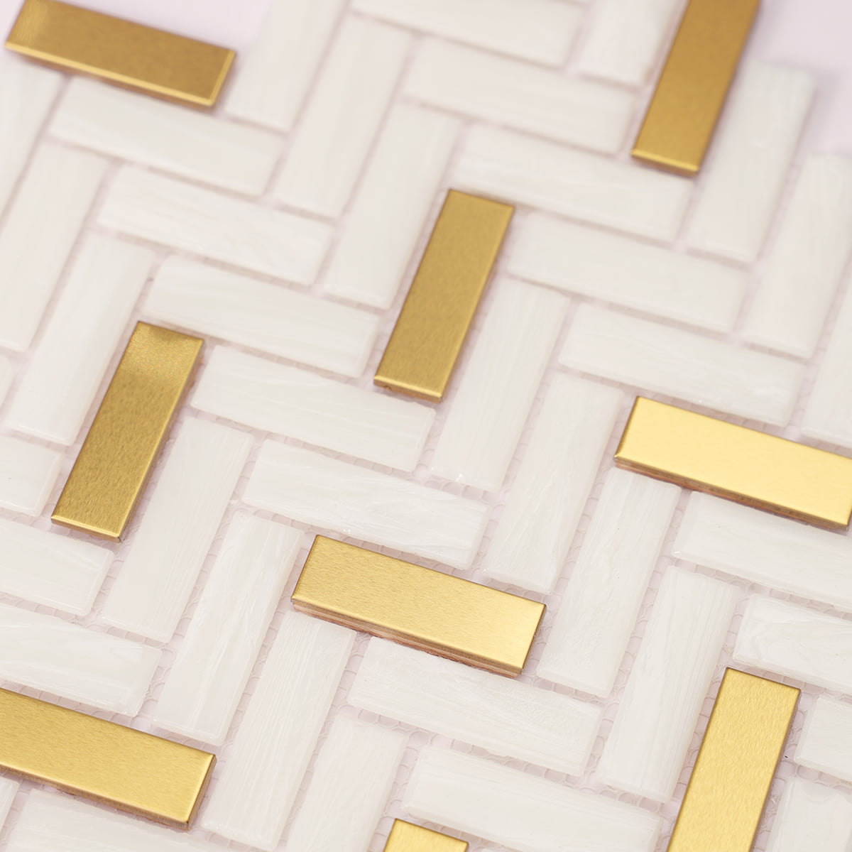 Soft focus close-up showing textured glass and gold herringbone tiles