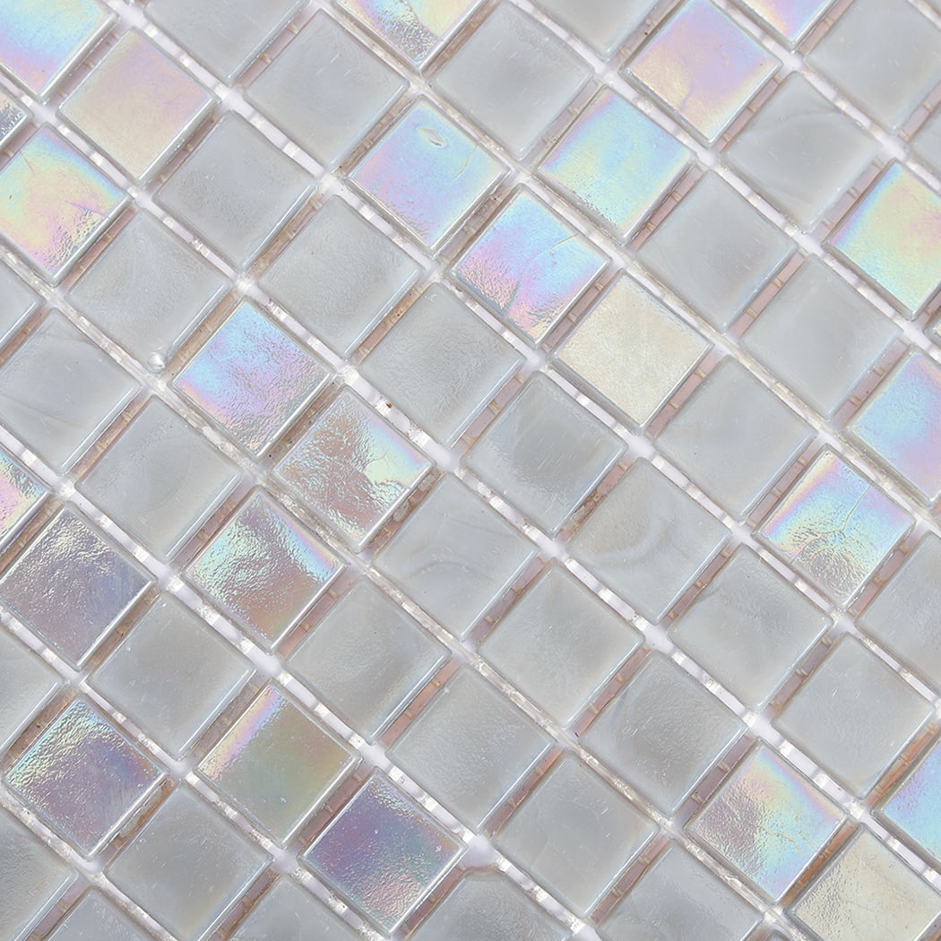 Macro view of iridescent light gray square glass tiles highlighting reflective surface finish