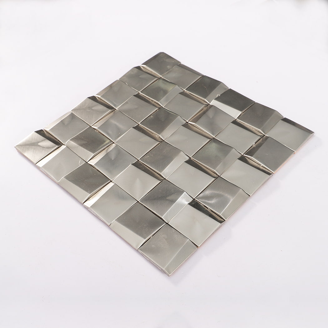 Perspective view of stainless steel beveled square mosaic tile sheet laid on white surface.