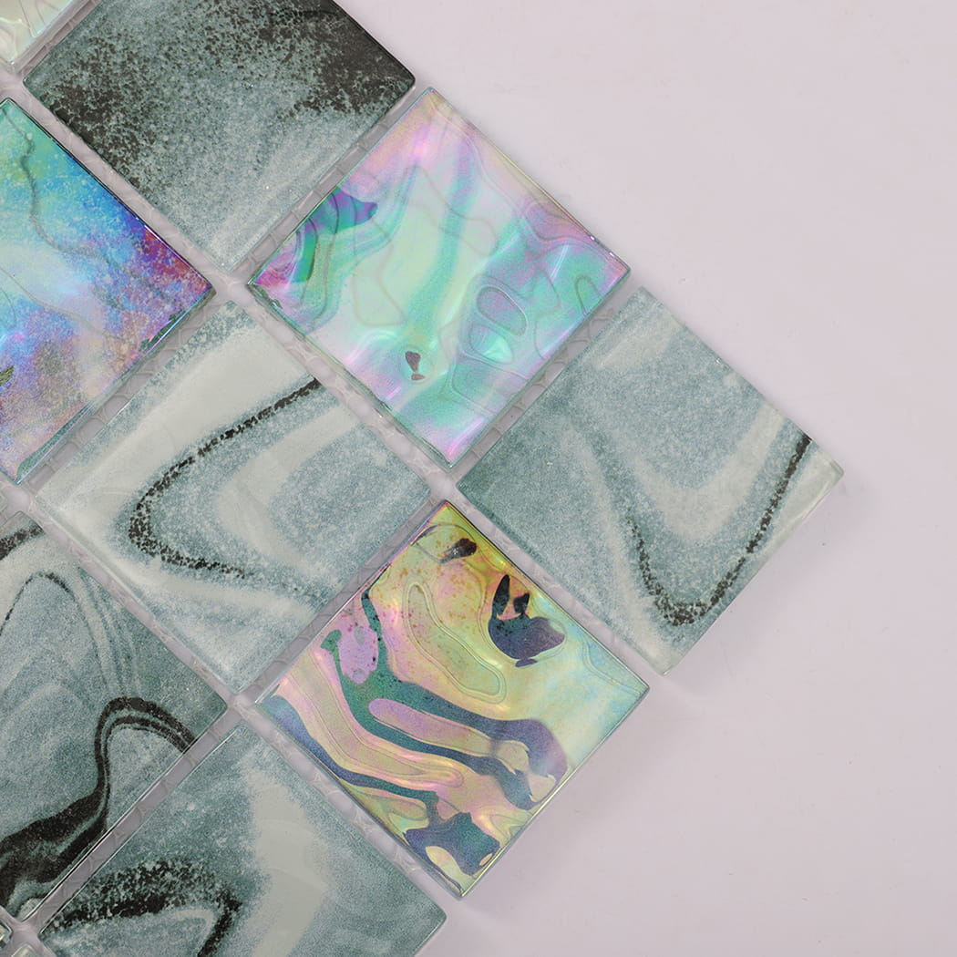 Close-up of teal gray glass mosaic tiles with blue and pink iridescent accents
