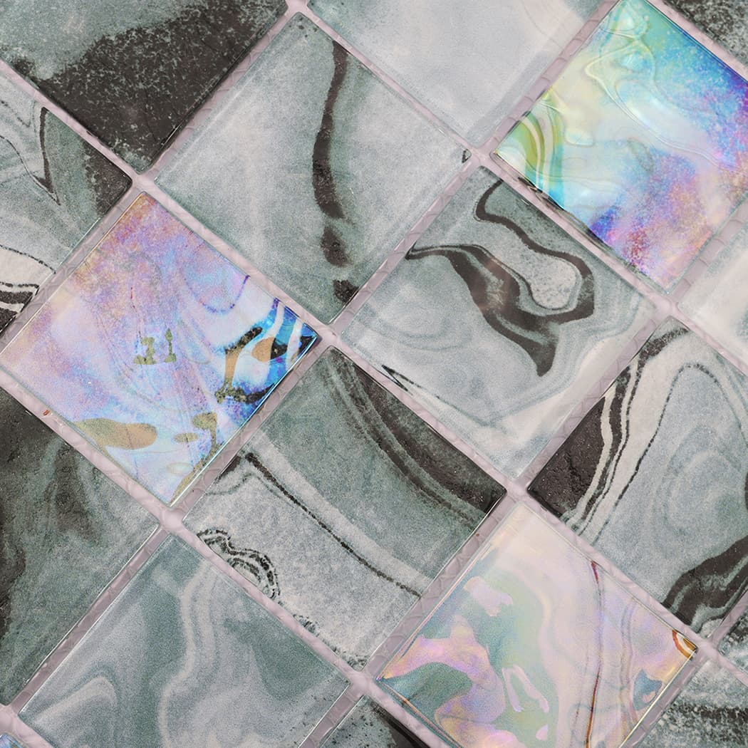 Detailed view of teal gray square glass mosaic with iridescent accent tiles
