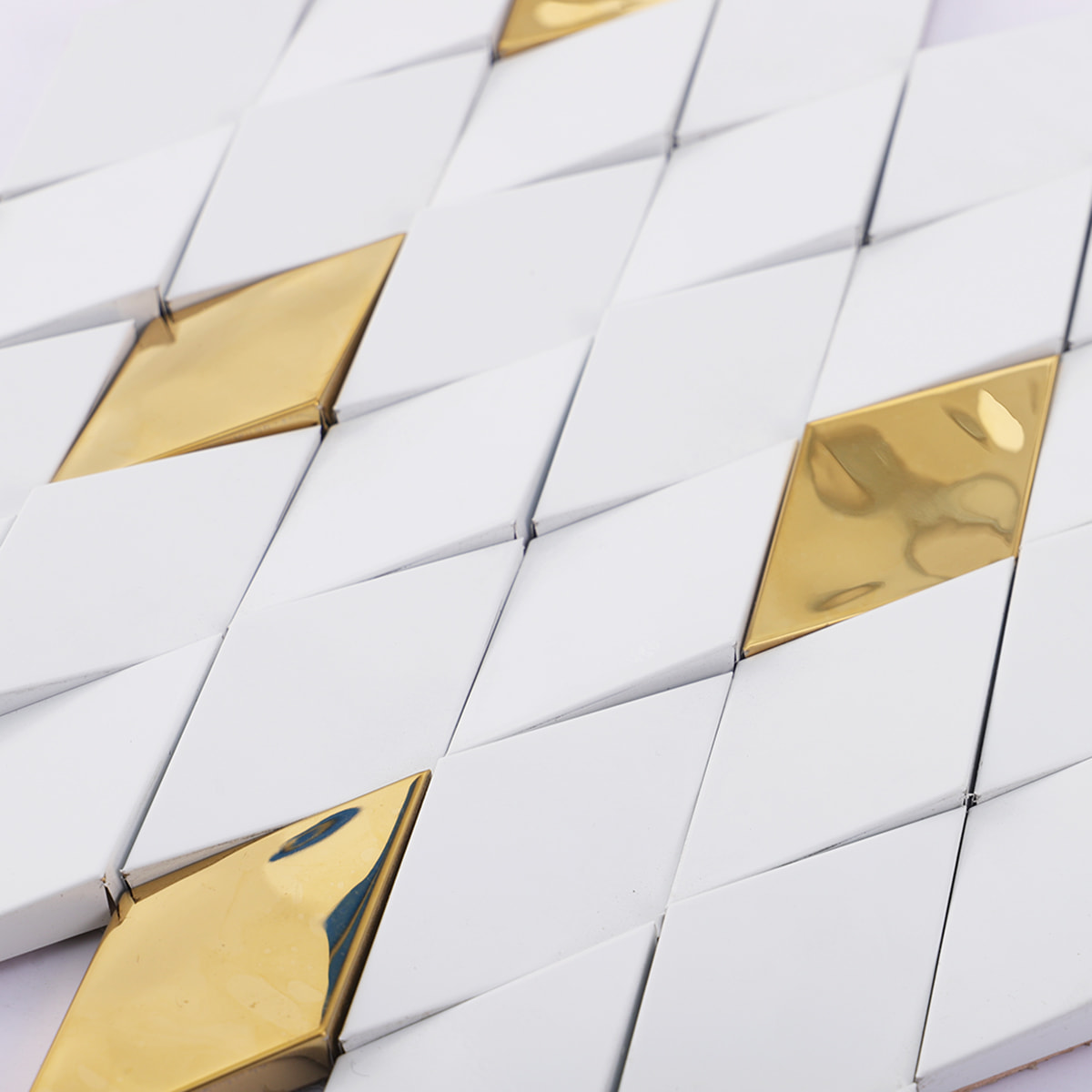 Macro view of the brilliant cut textured surface on white and gold tiles.