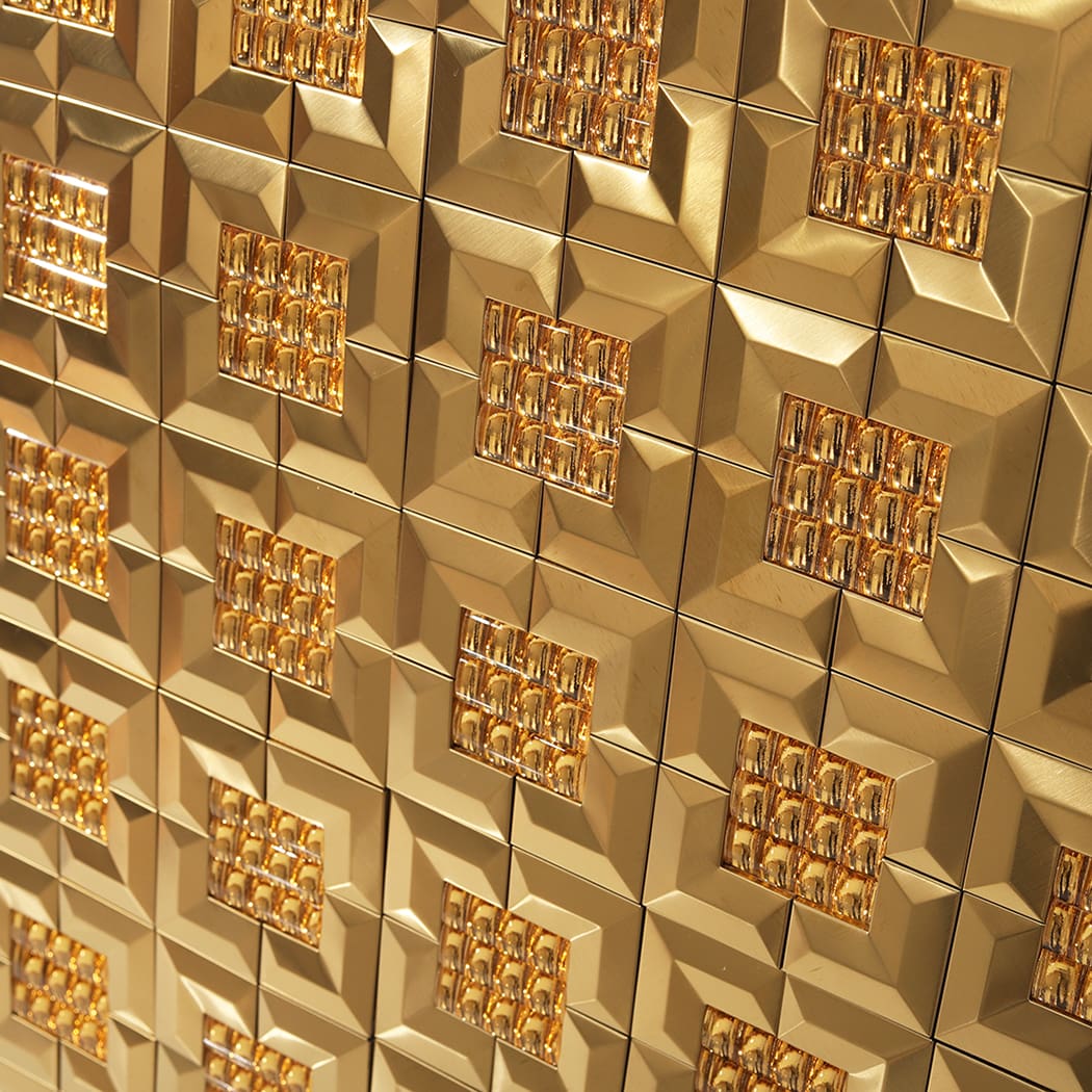 A close up angled shot of gold 3D mirror tiles showing the intricate textured centers.