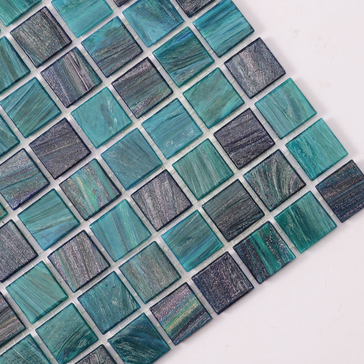 Textured teal glass mosaic tiles featuring a mix of dark and light shades for contrast 