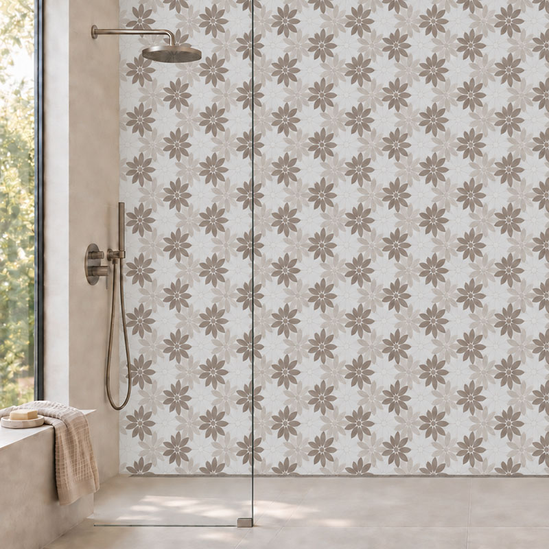 Close view of white beige floral marble mosaic tiles on a modern shower wall.