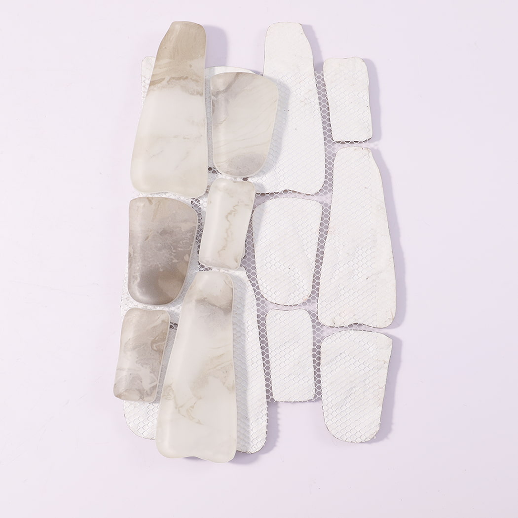 Back view of white beige irregular mosaic tile sheet with mesh backing