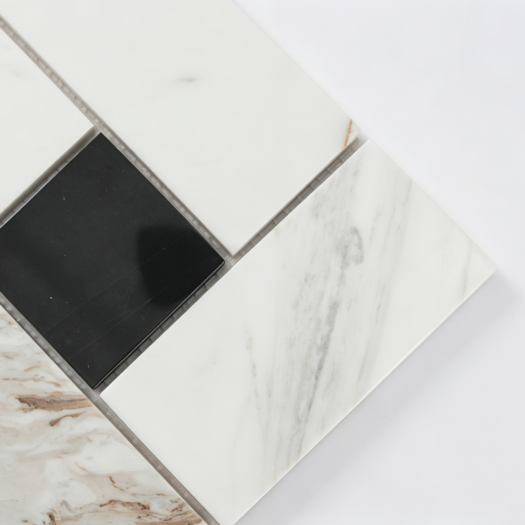 Close-up of white veined marble and black square mosaic tiles