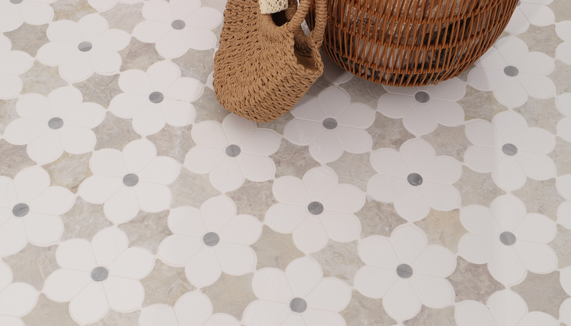White floral marble mosaic floor tile with gray dot accents and soft stone background