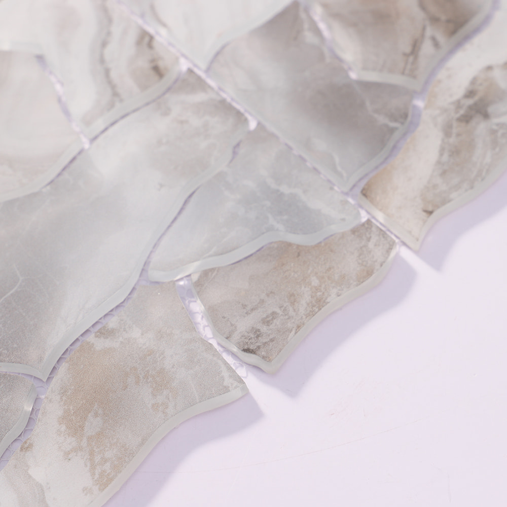 Angled view of white gray irregular glass mosaic tiles with smooth edges