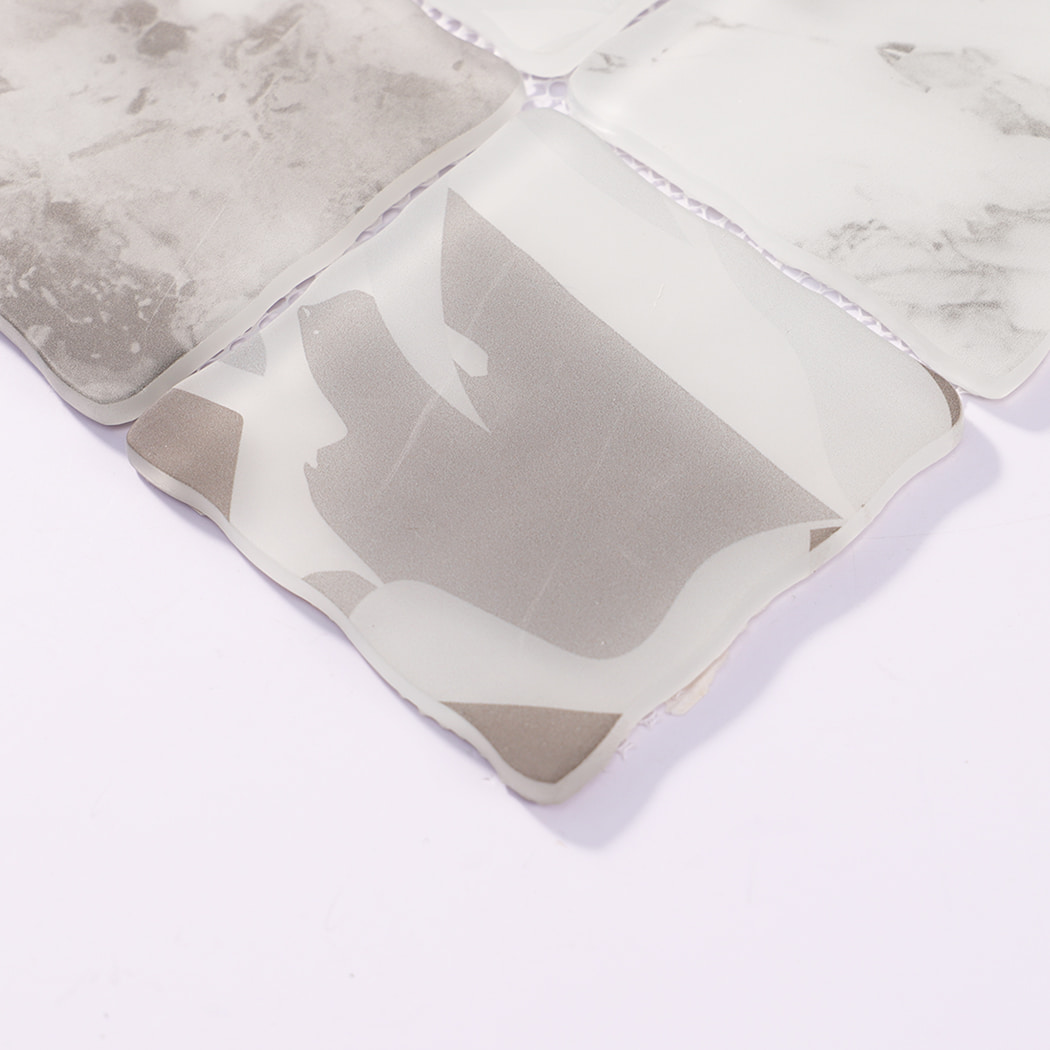 Edge detail of white gray patterned wavy square glass mosaic tiles
