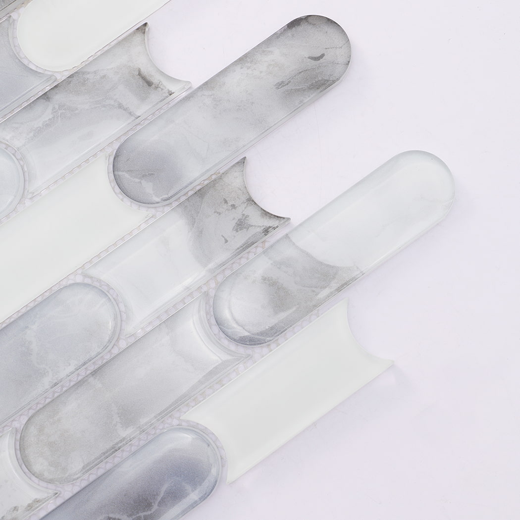 Close up of white gray patterned and pill shaped glass mosaic tiles