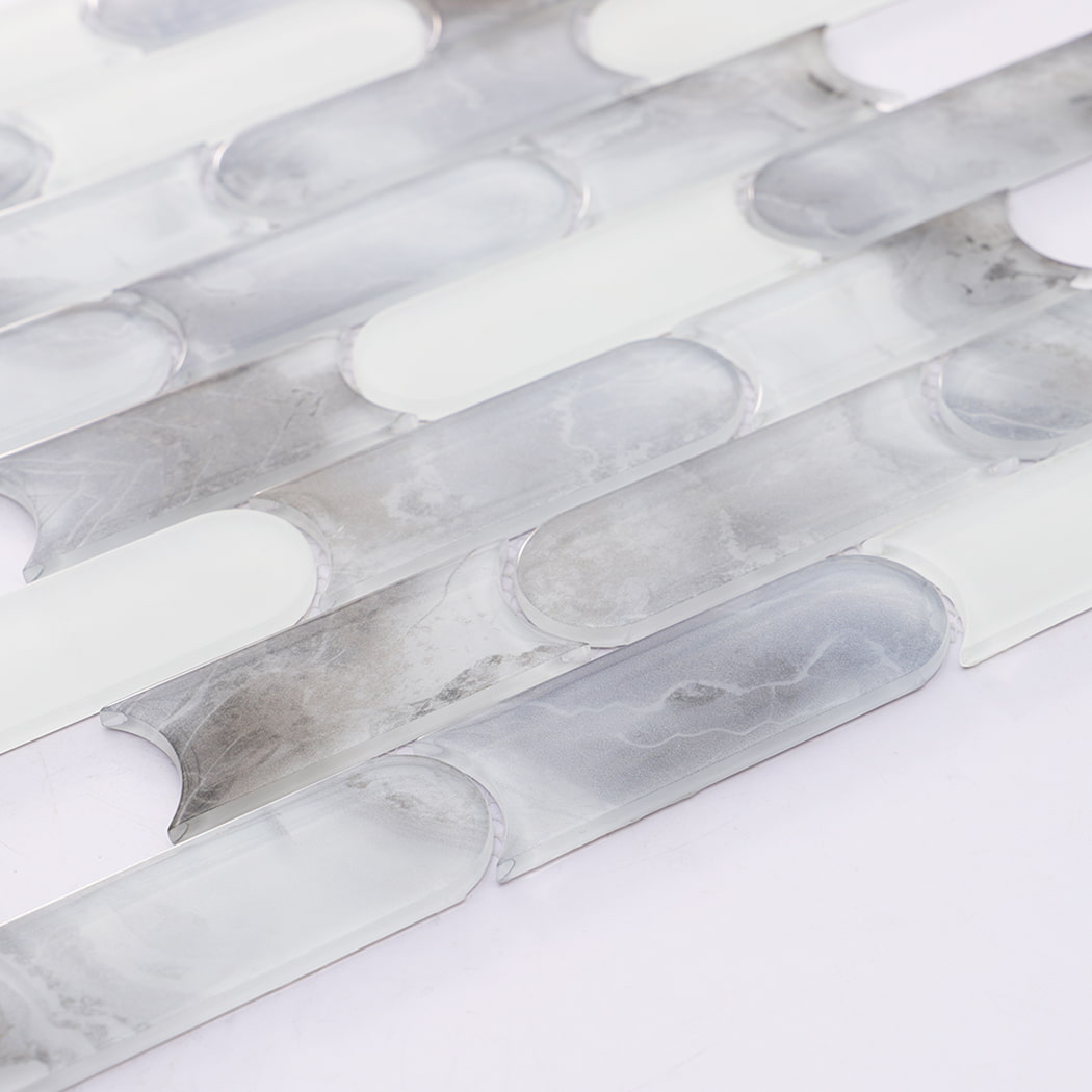 Detailed view of white gray pill shaped glass mosaic tile pattern