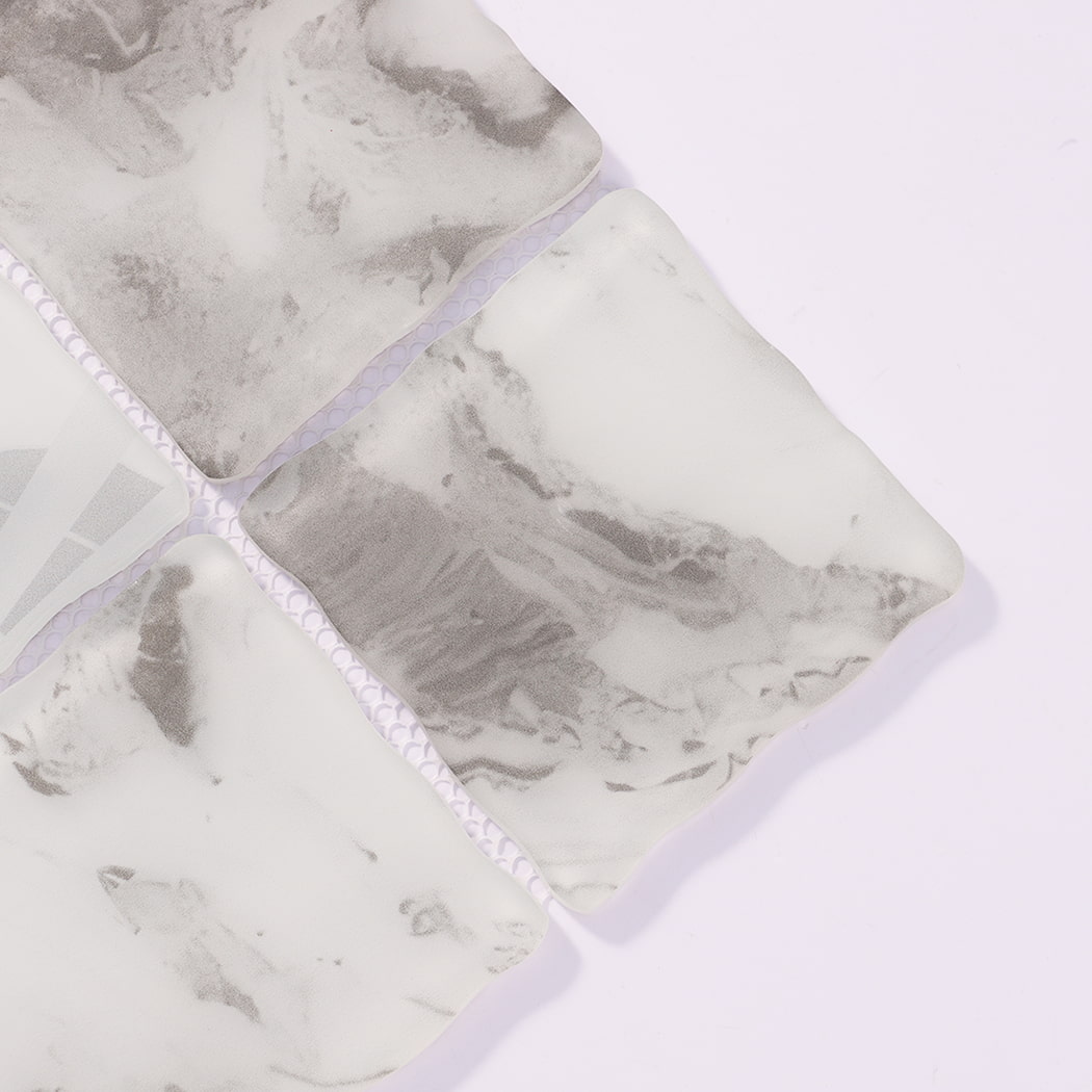 Close-up of white gray wavy square glass mosaic tiles with cloudy patterns