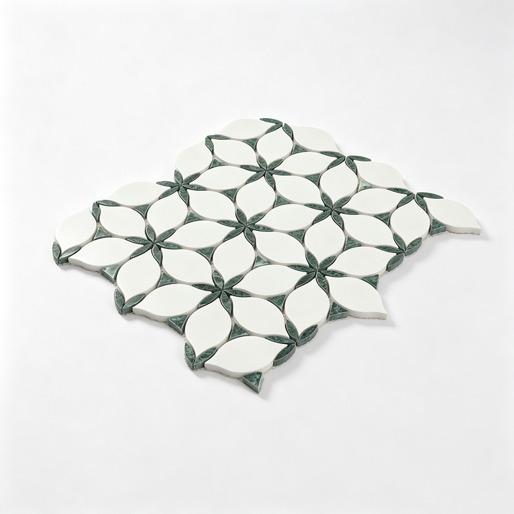 Angled view of white and green marble leaf mosaic tile sheet