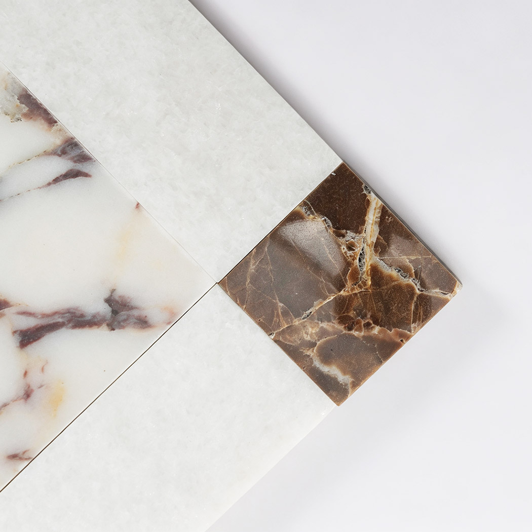 White veined marble center and brown corner detail of border mosaic tile