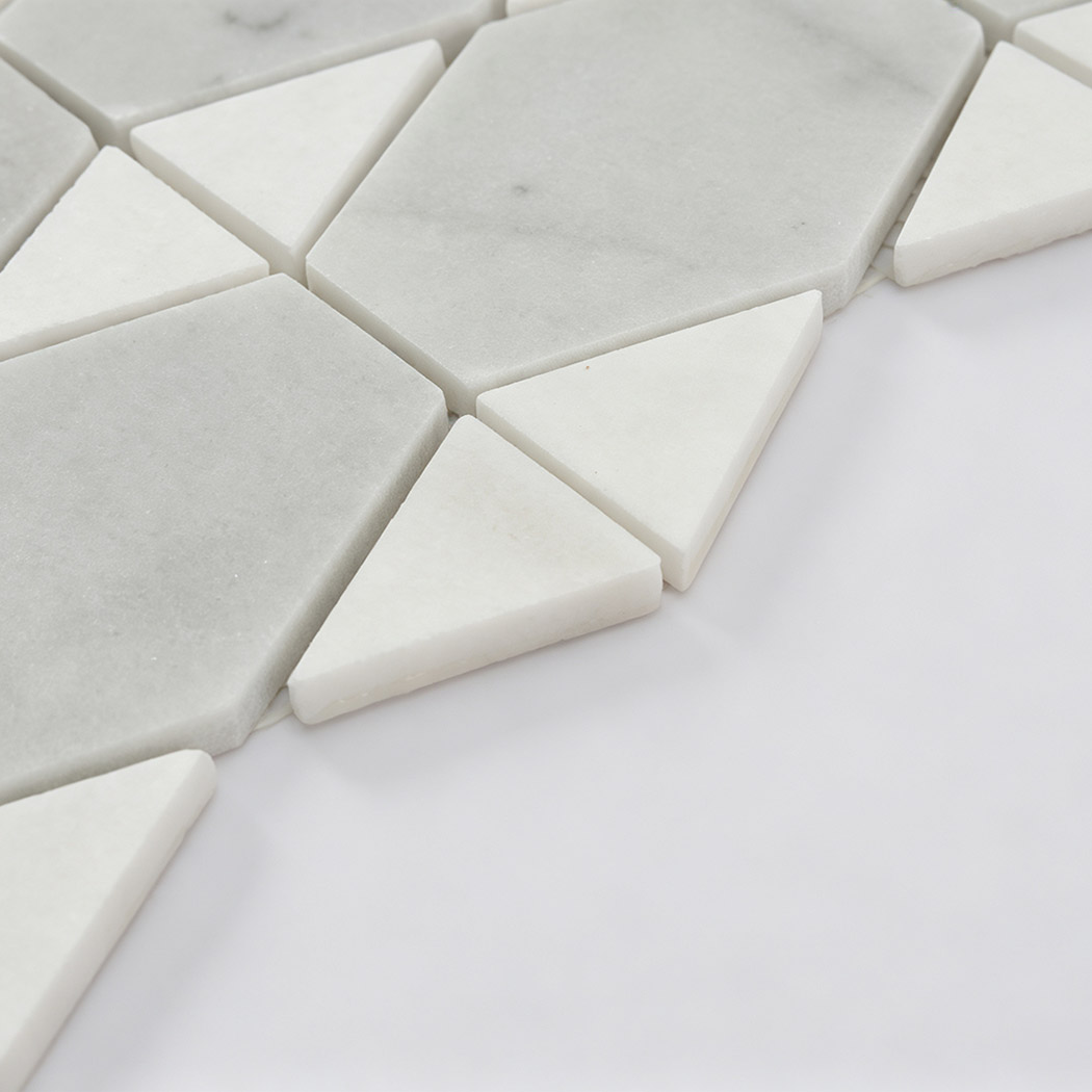 Side view of white marble geometric mosaic tiles with triangular accents