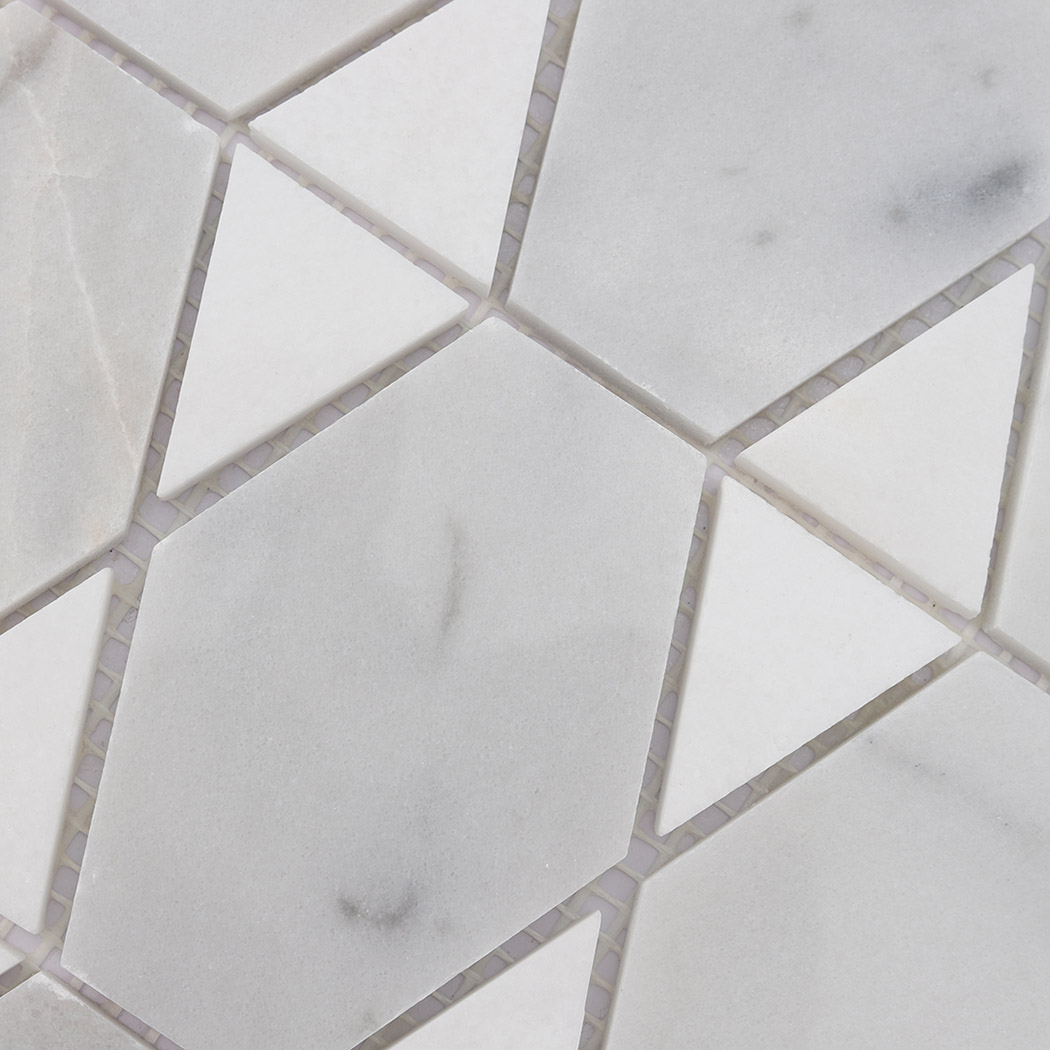 White marble hexagon and triangle mosaic tile detail with soft natural veining