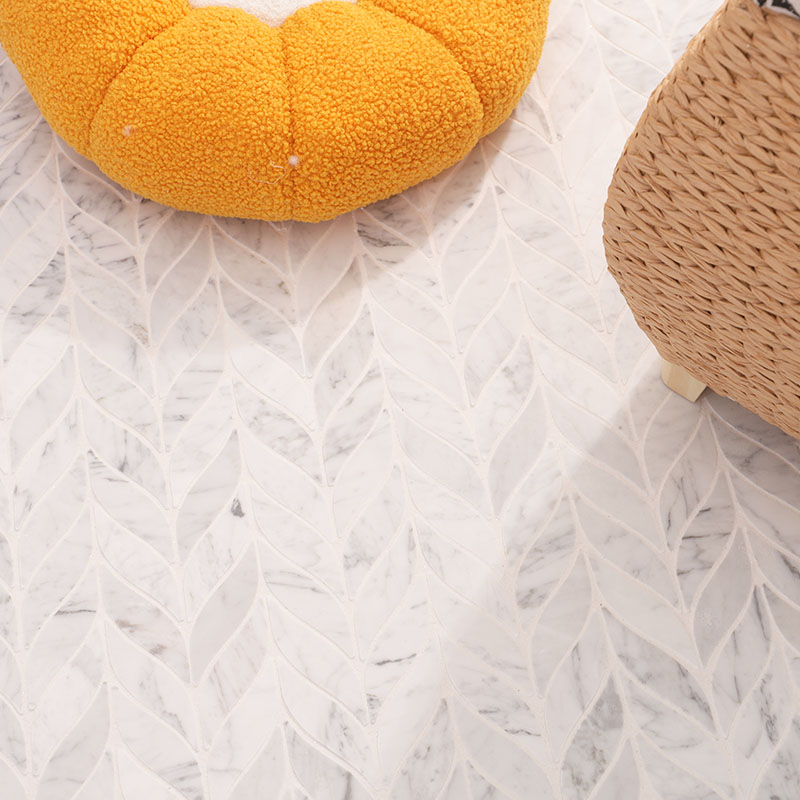 White marble leaf mosaic floor with soft gray veining in a cozy interior