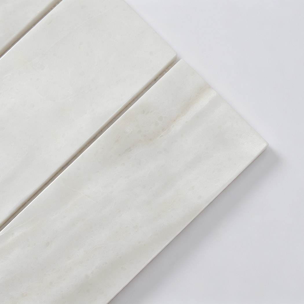 Close-up of white marble linear mosaic tile surface
