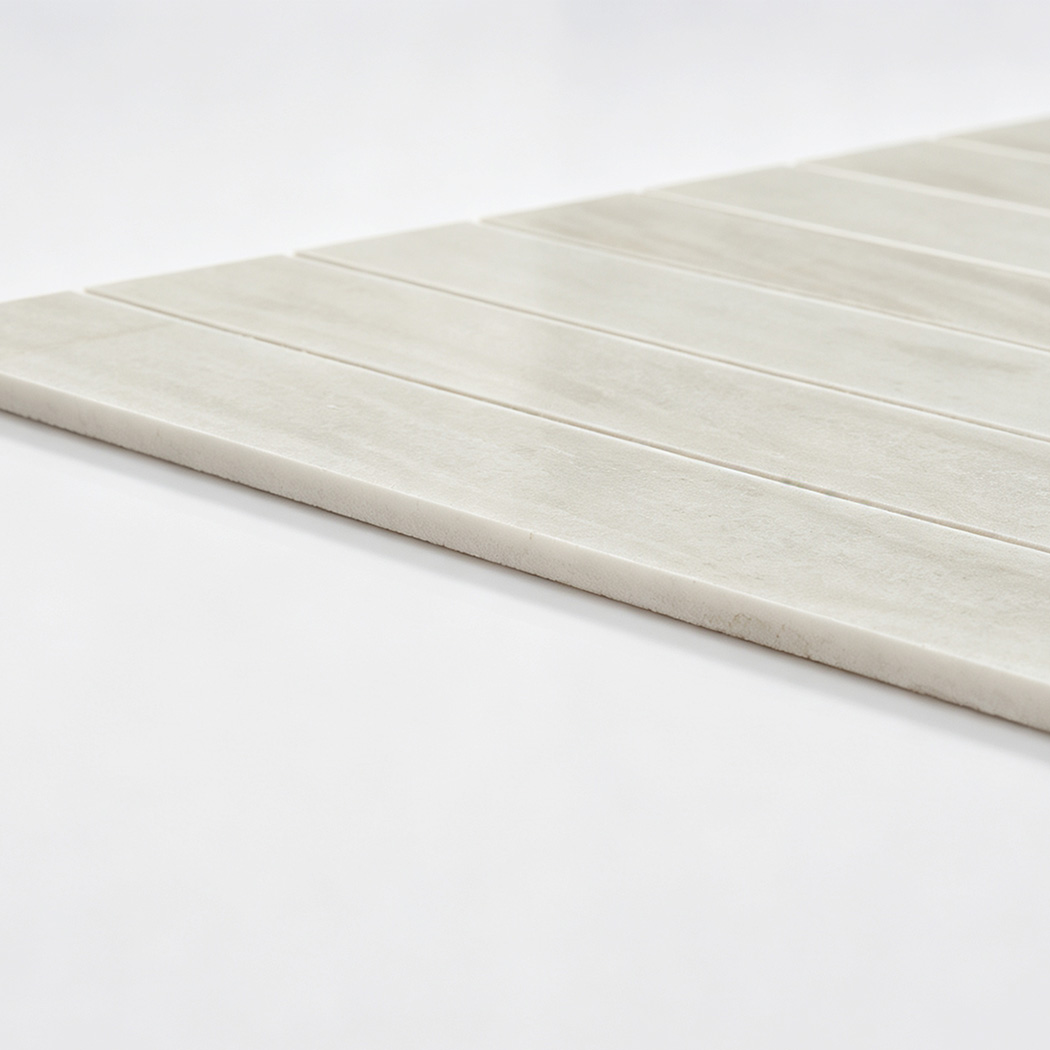 Side view showing the edge of white marble linear mosaic tile