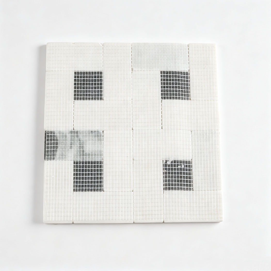 Mesh backing of white marble geometric mosaic tile with black square accents