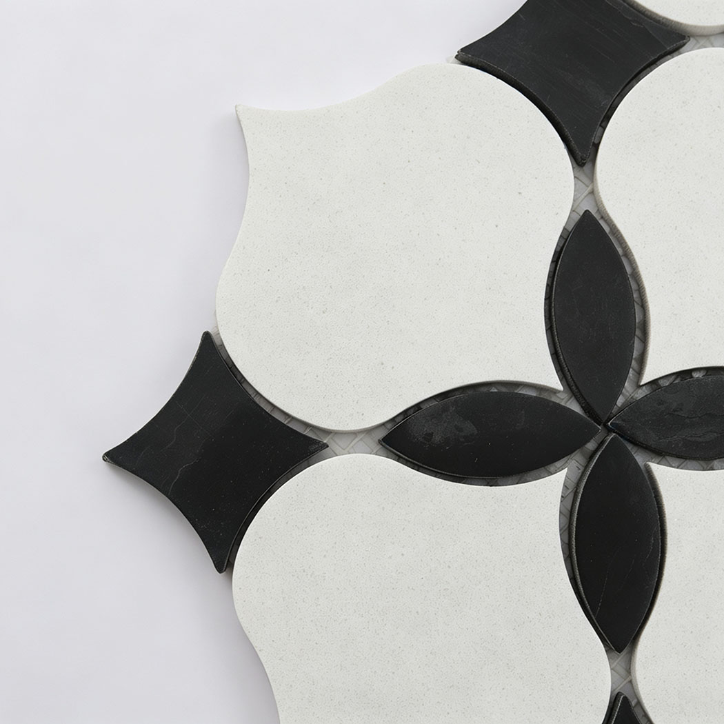 Close-up of white and black floral mosaic tile with curved geometric shapes