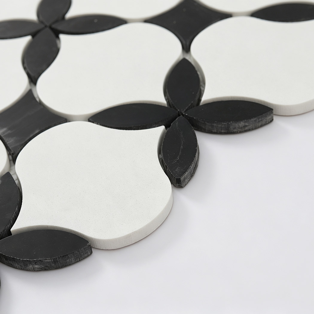 Side view of white and black floral waterjet mosaic tiles