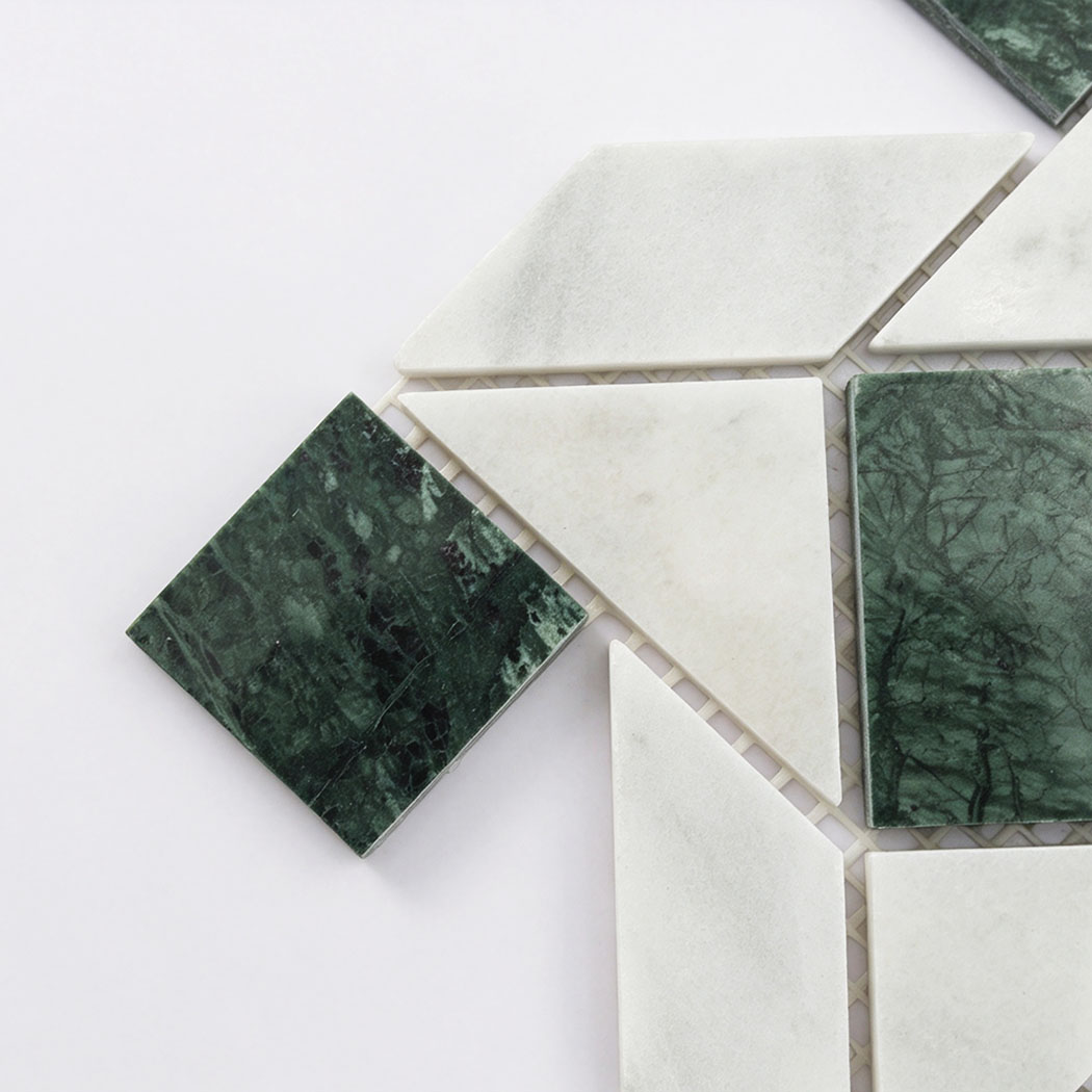 Close-up of white and green marble geometric mosaic tile corner detail