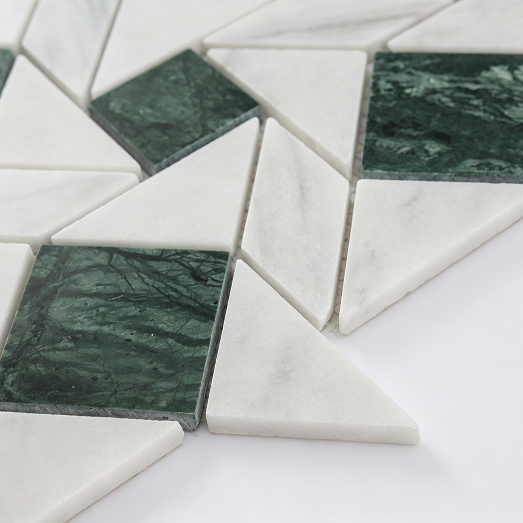 Side view of white geometric marble mosaic tiles with green marble accents
