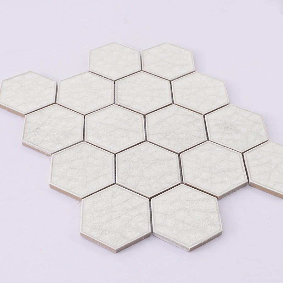 Angled view of white hexagon mosaic tile sheet