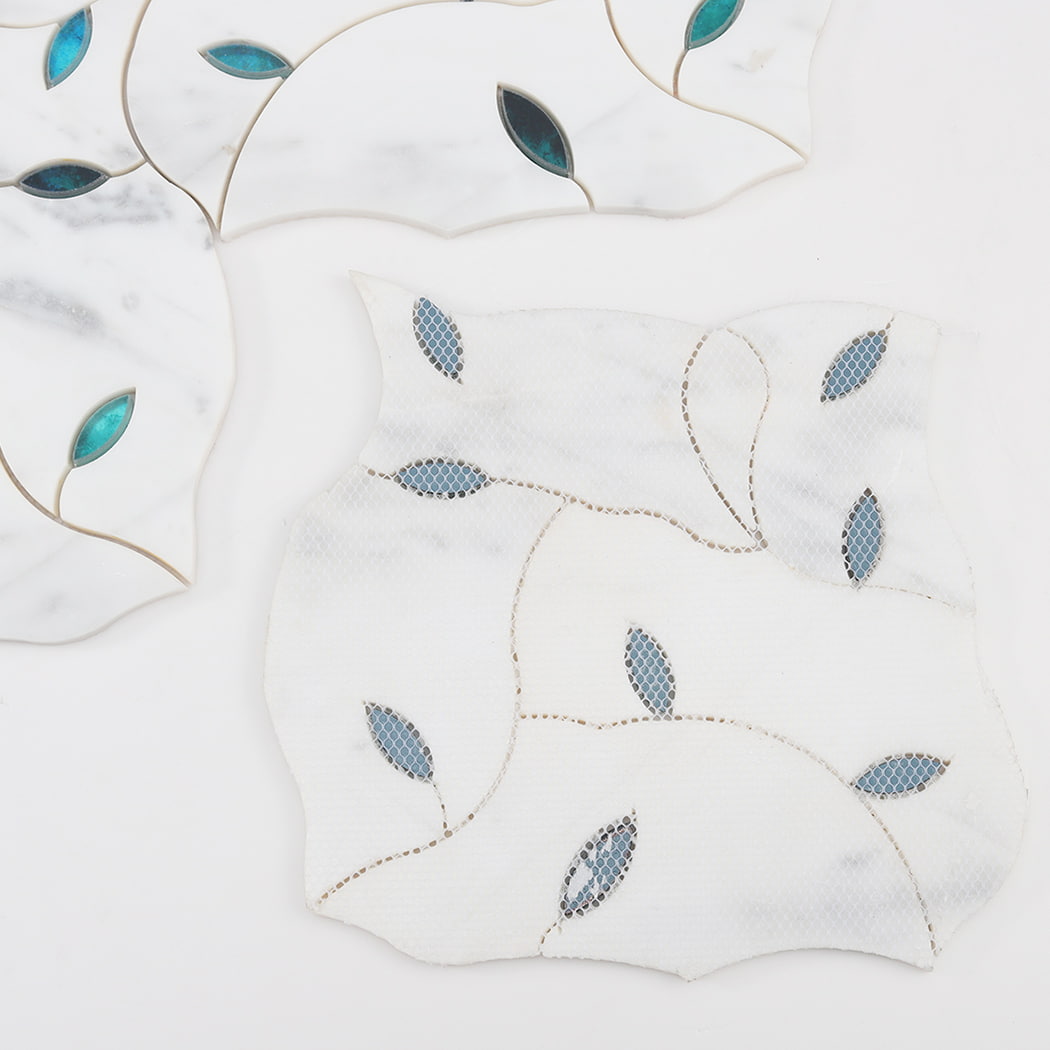 Back side of white marble and glass waterjet mosaic tile sheet with mesh backing