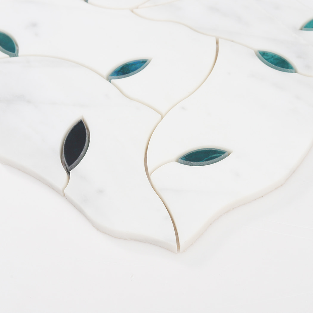 Angled view of white marble and glass mosaic tile showing thickness and curved edges