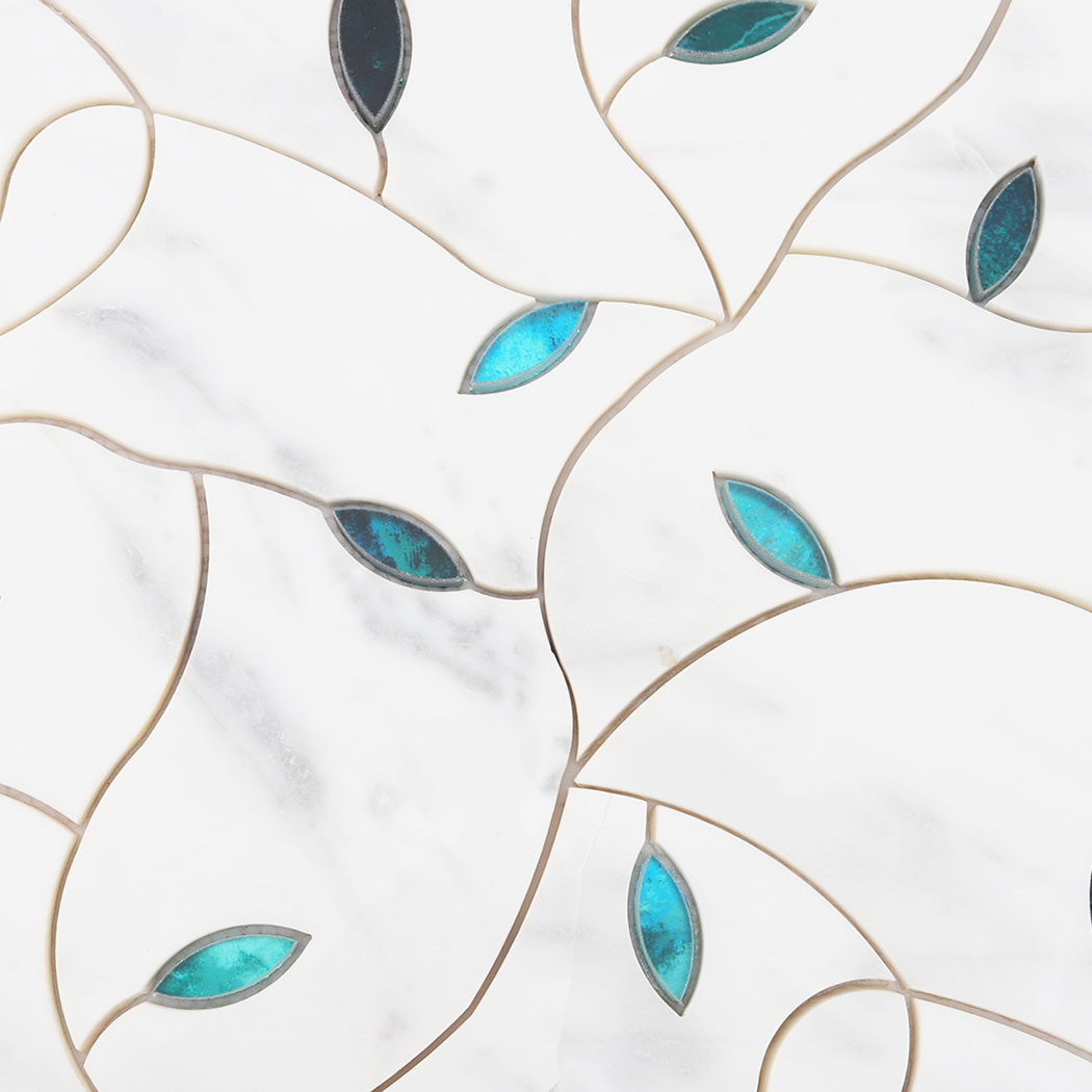 Detailed view of curved white marble mosaic pattern with teal glass leaf accents