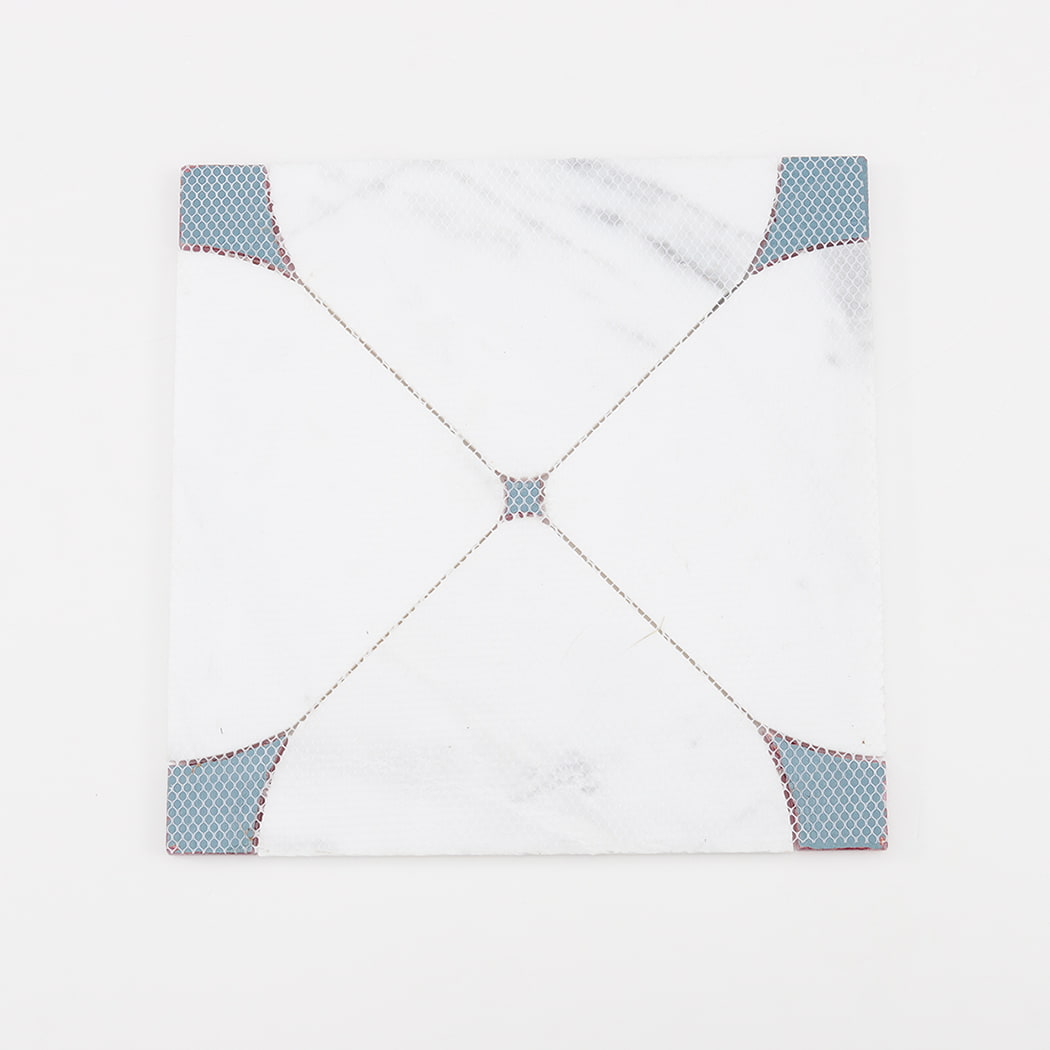 Back side of white marble waterjet mosaic wall tile showing mesh backing for installation