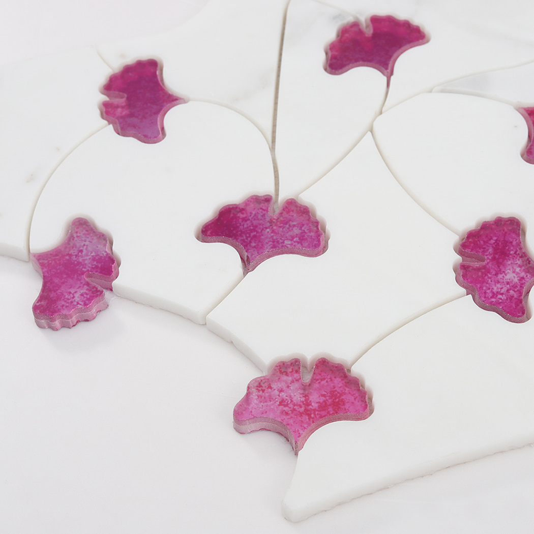 Close-up of white marble base with pink glass waterjet mosaic corner detail